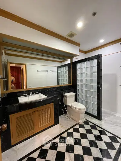 Luxurious bathroom with elegant black and white marble flooring and modern fixtures