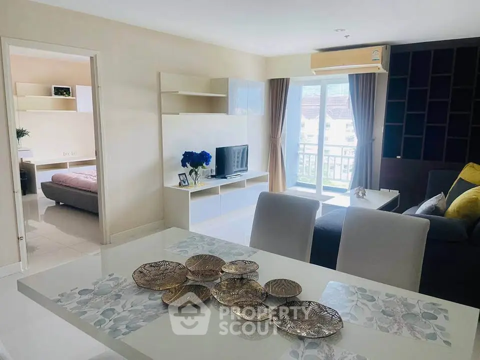Modern living room with elegant decor and balcony view in a stylish apartment.