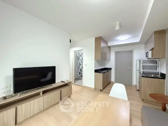 Modern open-plan living room with sleek kitchen and stylish decor