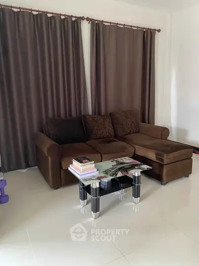 Cozy living room with plush brown sofa and modern glass coffee table