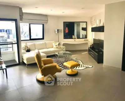 Spacious modern living room with city view and stylish yellow chairs