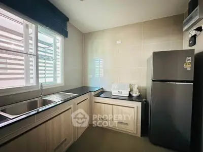Modern kitchen with sleek cabinetry and stainless steel appliances in a bright, airy space.