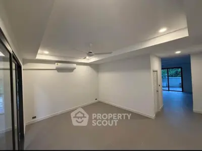 Spacious modern living room with ceiling fan and air conditioning