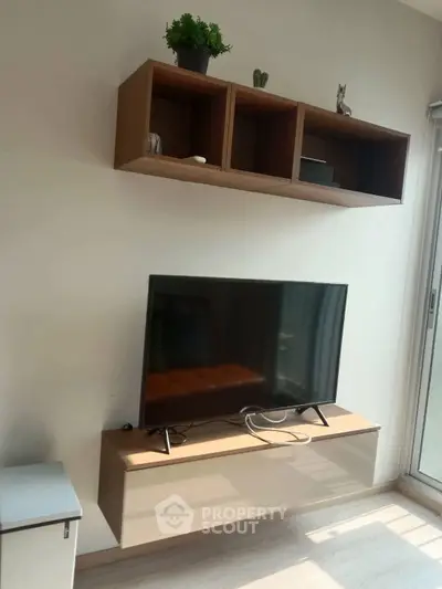 Modern living room with wall-mounted TV and stylish shelving unit