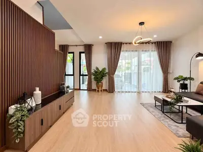 Spacious modern living room with elegant decor and large windows for natural light.
