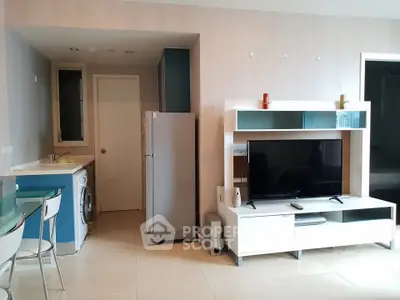 Modern living room with sleek furniture and integrated kitchen appliances in a stylish apartment.