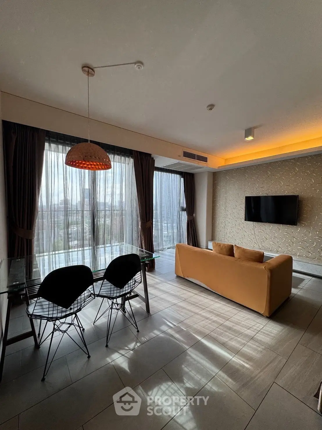 Modern living room with stylish furniture and large windows offering a stunning view.