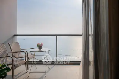 Stunning ocean view from a modern balcony with elegant seating and decor.