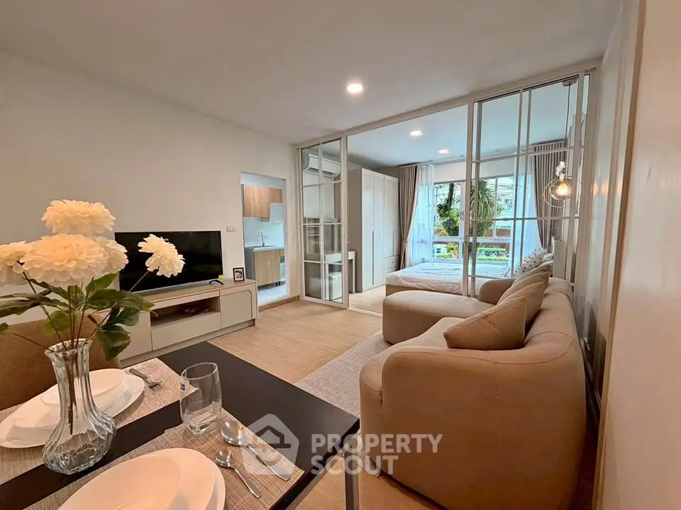 Modern open-plan living room with cozy seating and elegant dining area