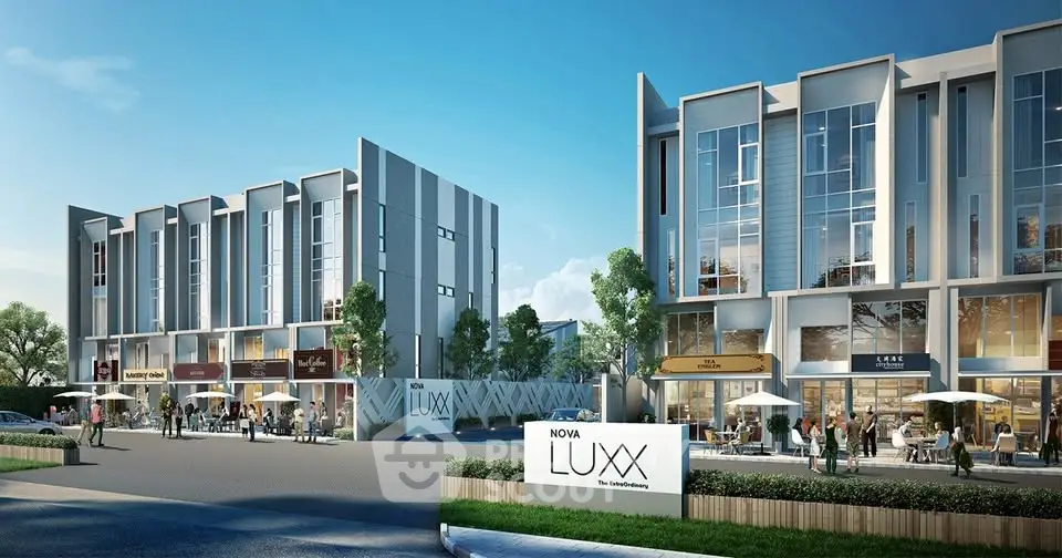 Modern commercial complex with sleek architecture and outdoor seating in vibrant urban setting.
