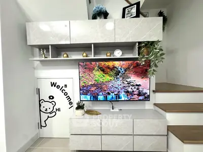 Modern living room with stylish storage and vibrant TV display