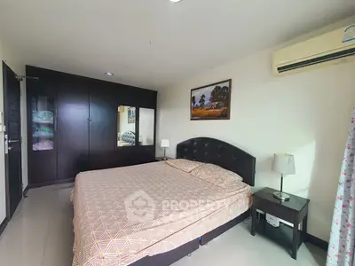 Spacious bedroom with elegant decor and ample natural light
