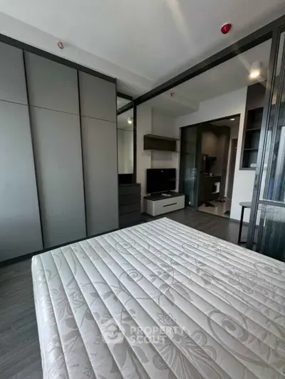 Modern bedroom with sleek design and ample storage in a contemporary apartment.