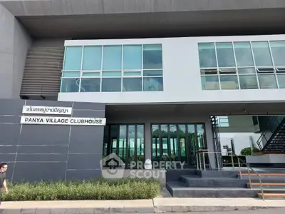 Modern clubhouse exterior with large windows and sleek design in Panya Village.
