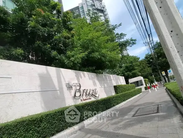 Luxurious condo entrance with lush greenery and modern design at The Breeze by Eastern Star.