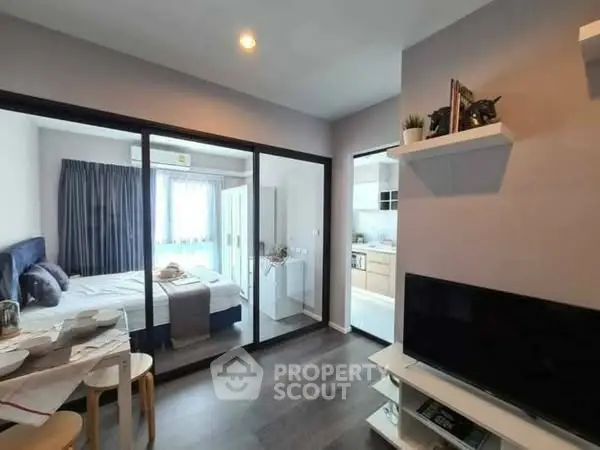 Modern apartment with open layout, featuring a cozy bedroom and stylish living area.