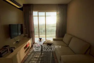 Cozy living room with large window and modern furnishings, perfect for relaxation.