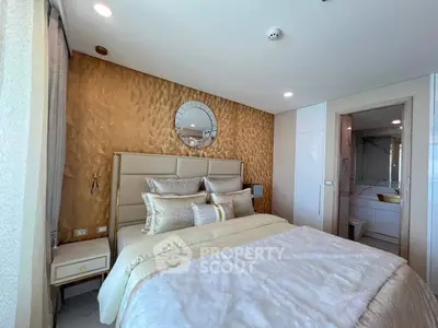 Luxurious bedroom with elegant decor and ensuite bathroom in modern apartment