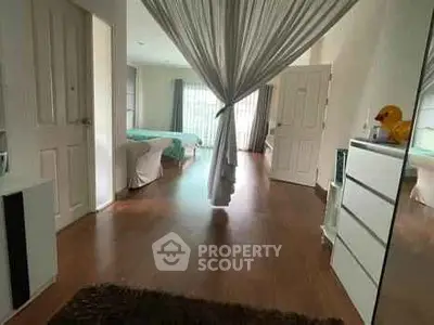 Spacious bedroom with elegant decor and natural light