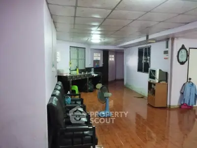 Spacious living room with tiled floor and basic furnishings, ideal for customization.