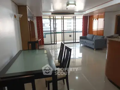 Spacious living room with modern furniture and large windows offering natural light.