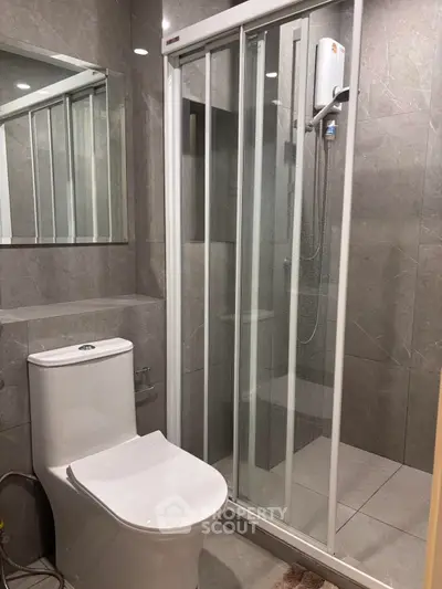 Modern bathroom with sleek shower and elegant fixtures in a contemporary apartment.