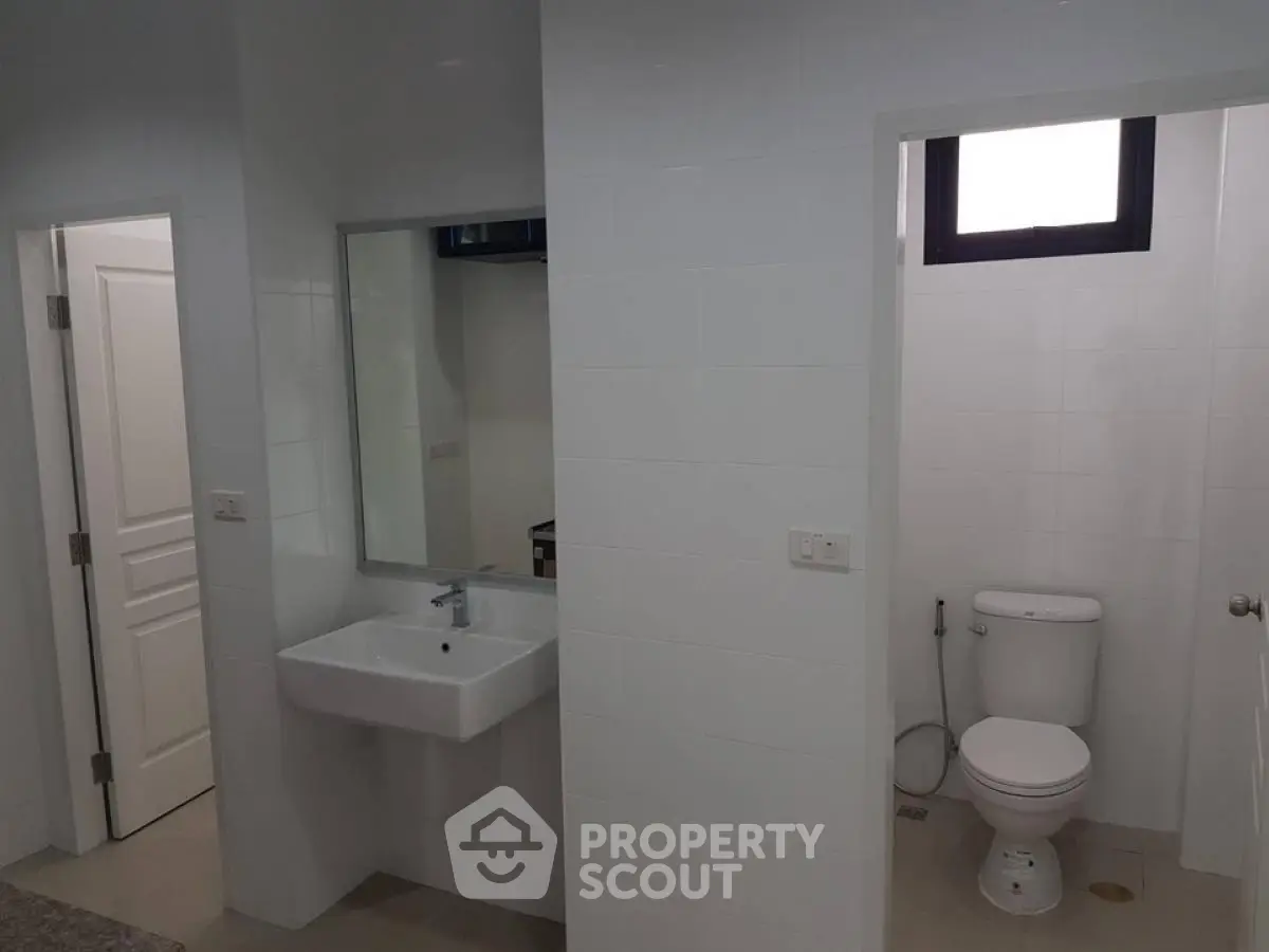 Modern bathroom with sleek white tiles and contemporary fixtures