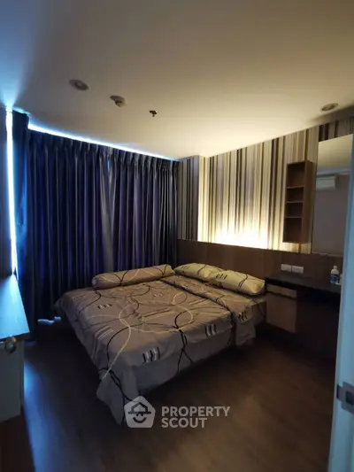Cozy bedroom with modern decor and ambient lighting, featuring a comfortable double bed and stylish curtains.