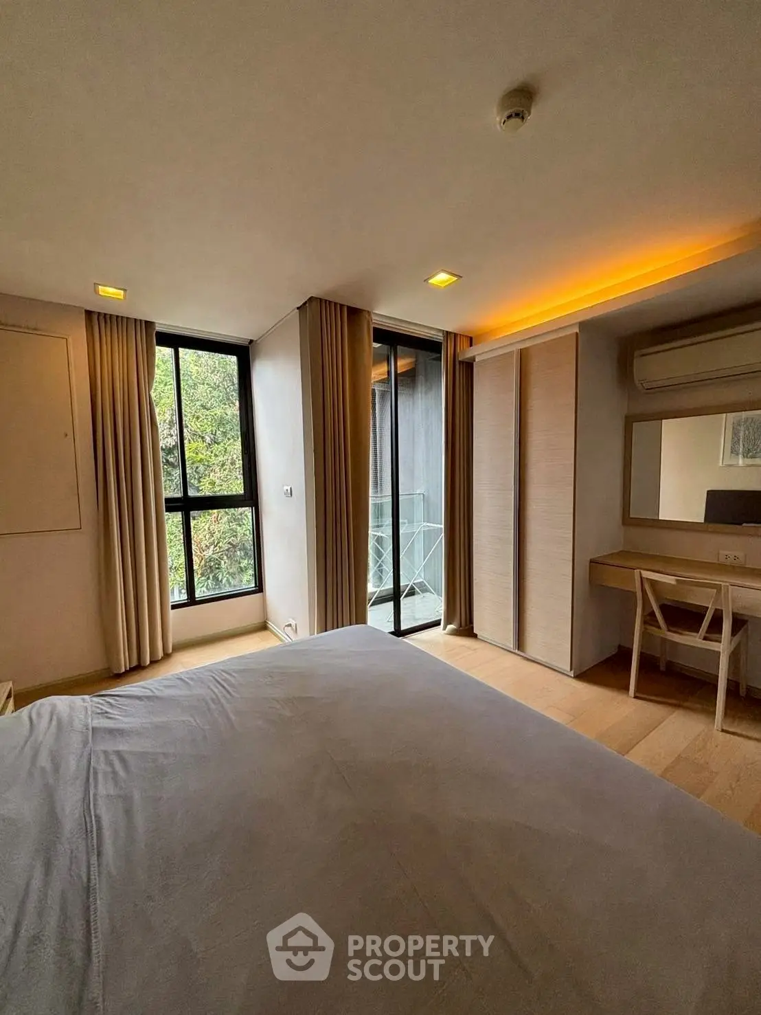 Spacious bedroom with modern decor and balcony access