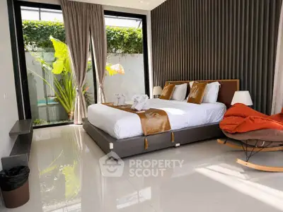 Luxurious bedroom with modern decor and garden view, featuring elegant furnishings and natural light.