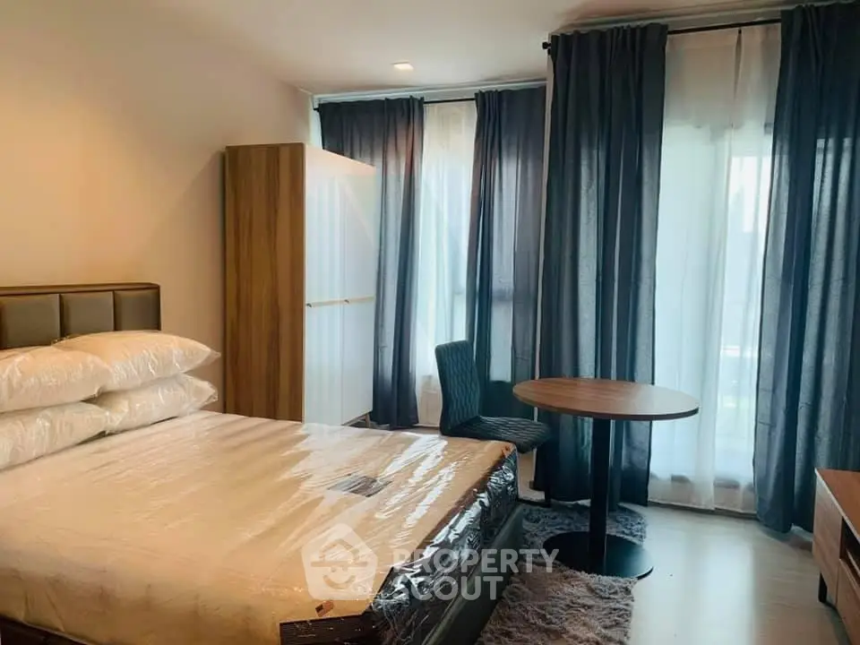 Modern bedroom with stylish furniture and large windows for natural light.