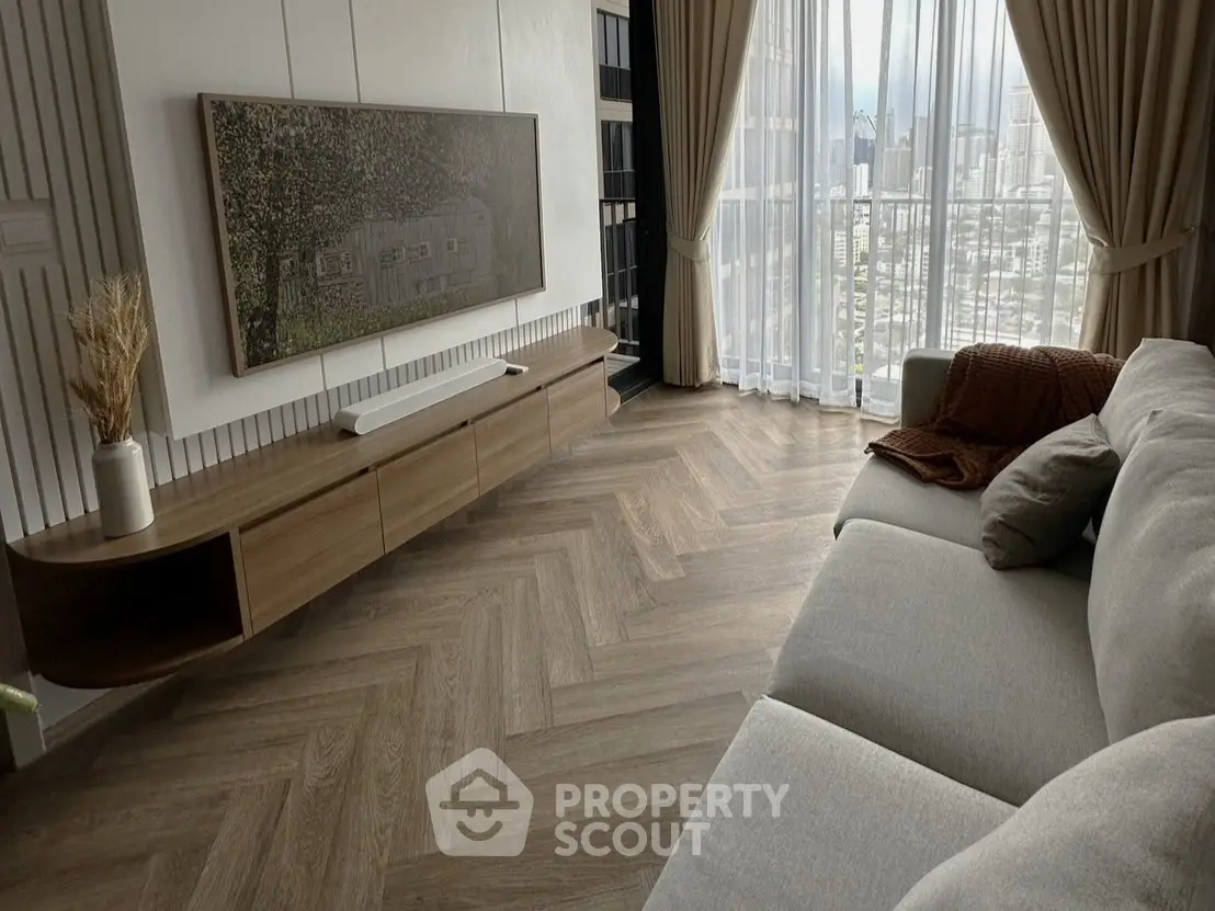 Modern living room with elegant decor and city view through large windows.