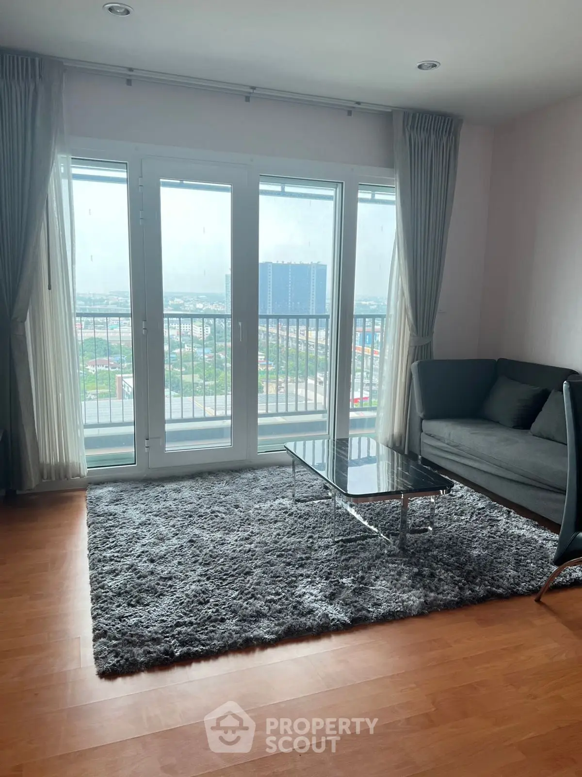Modern living room with large windows and balcony view