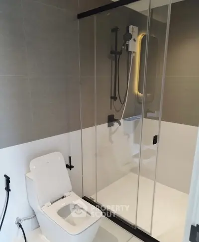 Modern bathroom with sleek shower enclosure and contemporary toilet design.
