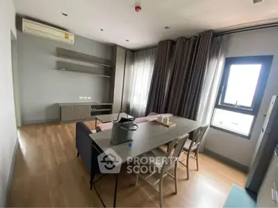 Modern living room with dining area and natural light
