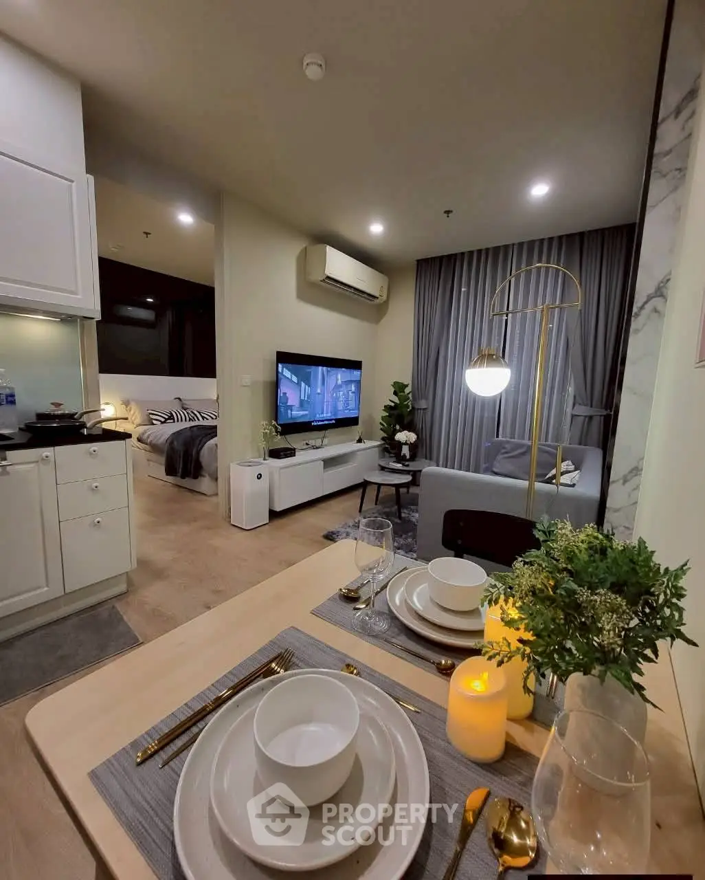 Modern open-plan living room with dining area, stylish decor, and cozy ambiance.