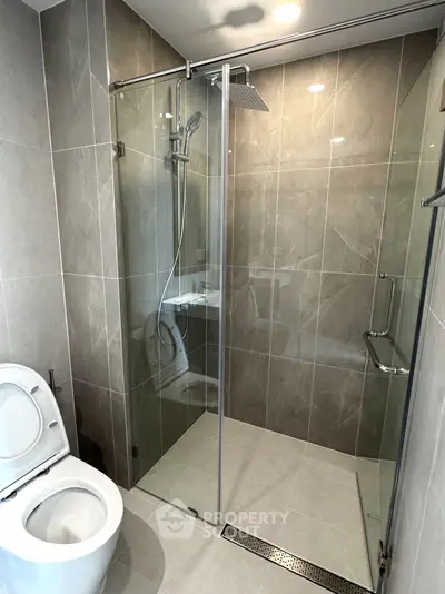 Modern bathroom with glass shower enclosure and sleek tile design