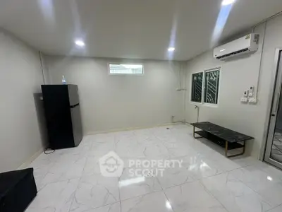 Spacious modern room with sleek marble flooring and air conditioning, ideal for versatile living arrangements.
