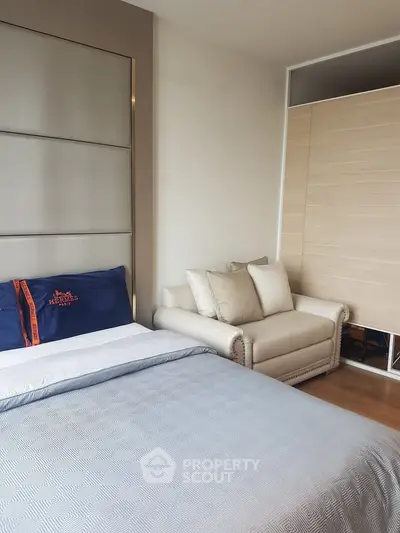 Cozy bedroom with elegant decor and comfortable seating area, perfect for relaxation.