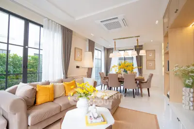 Elegant living room with modern decor, large windows, and cozy dining area, perfect for family gatherings.