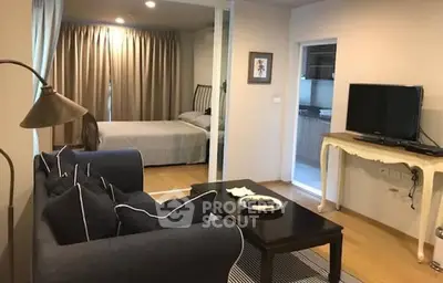 Cozy living room with adjacent bedroom in modern apartment