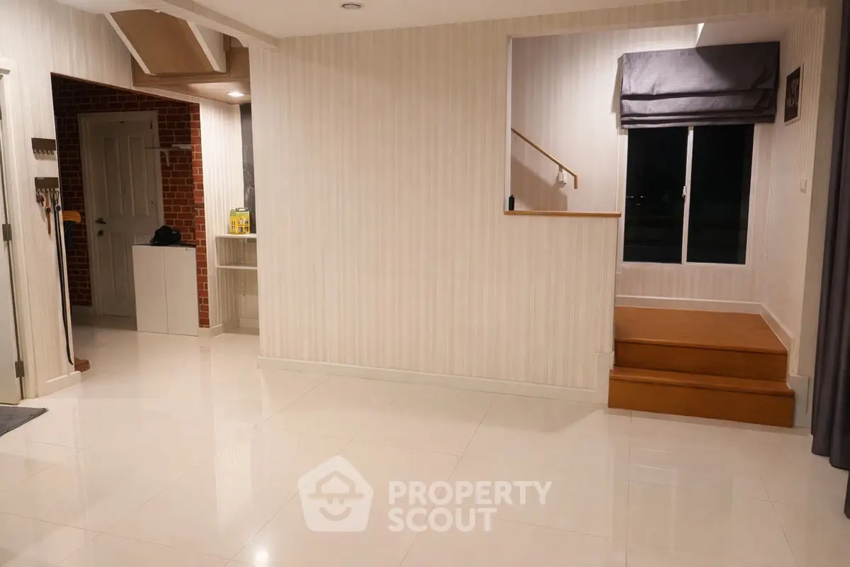 Spacious modern interior with elegant staircase and polished floors