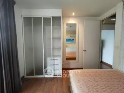 Spacious bedroom with built-in wardrobe and cozy ambiance