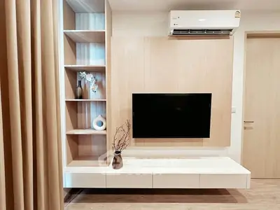 Modern living room with wall-mounted TV and stylish shelving unit