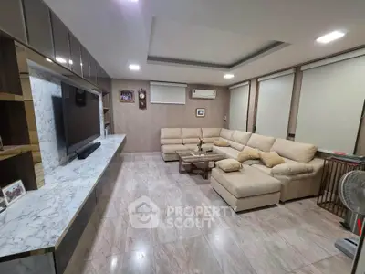 Spacious modern living room with elegant marble flooring and cozy sectional sofa.