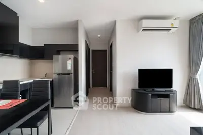 Modern open-plan living room with sleek kitchen and stylish furniture
