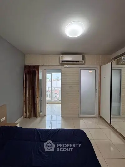 Spacious bedroom with balcony access and modern design