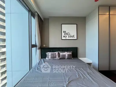 Modern bedroom with large window and stylish decor in urban apartment