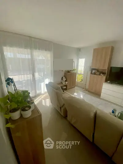 Bright living room with modern furniture and large windows