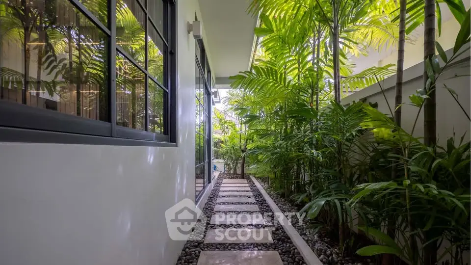 Serene garden pathway with lush greenery and modern design